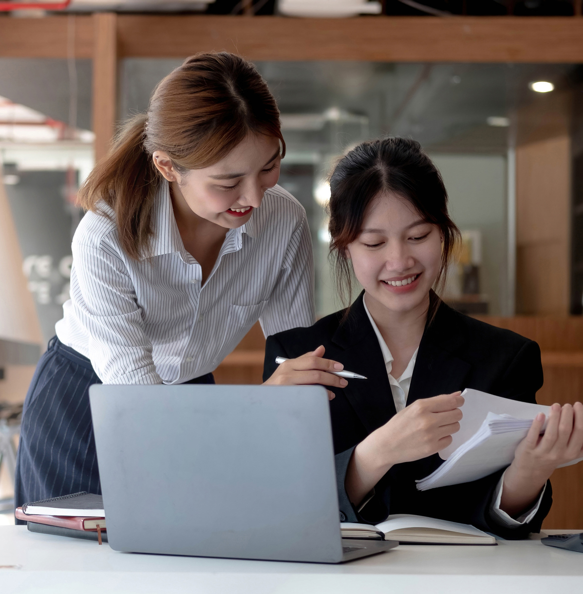 Two young asia business woman working together in office space